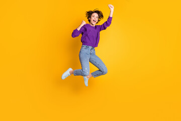 Fototapeta na wymiar Full length body size view of attractive lucky cheerful girl jumping rejoicing yeah isolated over bright yellow color background