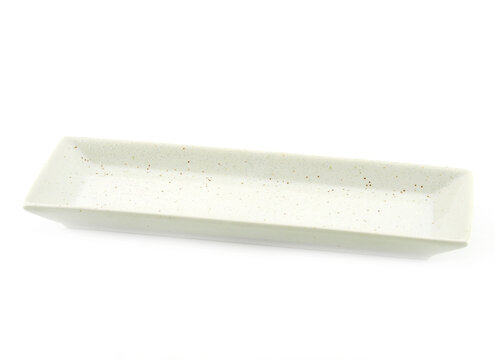 Empty long rectangle white plate with small brown dot isolated on a white background. Use for home or restaurant, food design. Kitchen accessory..