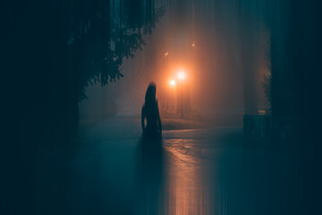 Horror halloween concept. strange silhouette in a dark spooky forest at night
