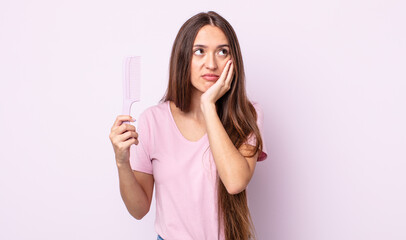 young pretty woman feeling bored, frustrated and sleepy after a tiresome. hair comb concept