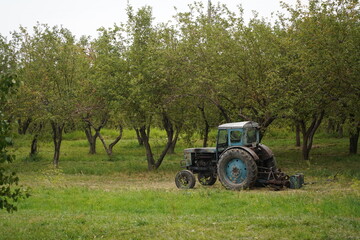 Almaty, Kazakhstan - 09.16.2021 : The tractor is on the territory of an apple orchard