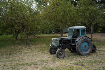 Naklejka premium Almaty, Kazakhstan - 09.16.2021 : The tractor is on the territory of an apple orchard