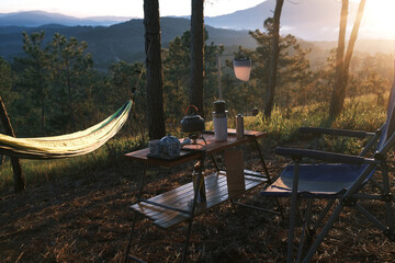 Coffee drip while camping in forest with sunshine. Coffee maker outdoor, campsite morning picnic...