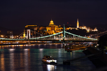 Fototapeta na wymiar Night Budapest, Buda Palace against the background of bridges, reflection of lights in the river