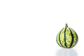 A selction of gourds, assorted colours and shapes shot landscape orientation on white background with natural reflection below, space for text