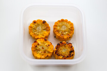 Oven baked corn in white box, tasty vegetable. Healthy eating concept