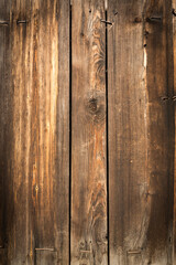 Wooden logs of an old house. Close-up. Weathered natural gray wood texture. Background. vertical photo.
