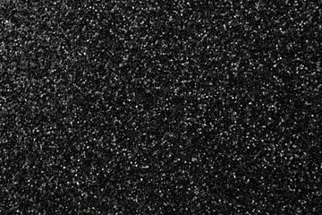 Black glitter texture background, glitter or sandpapper high detailed surface, shining glowing effects concept