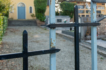 6 October 2021. Quattro Castella. Italy. Iron gate with crosses of a cemetery.