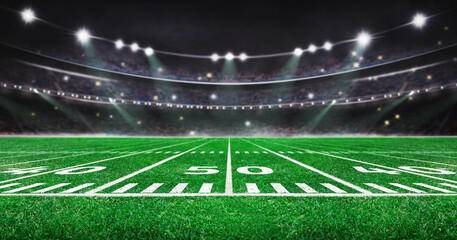 green field in american football stadium. ready for game in the midfield