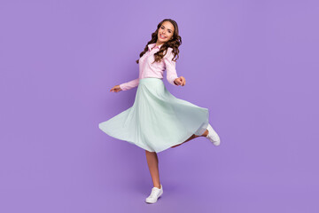 Full length body size view of pretty cheerful wavy-haired lady dancing having fun amusement isolated on violet purple color background