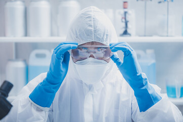 Closeup of hands of a young unrecognizable scientist, researcher and doctor wearing blue hand...