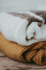 cozy sweaters on a wooden background 