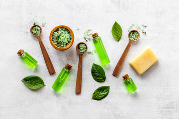 Fototapeta na wymiar Pattern of tea tree aroma essential oil with tea salt with green leaves