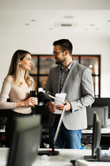 Colleagues in office. Businesswoman and businessman discussing work in office.