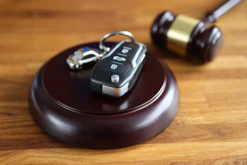 Referee gavel and remote control from car on table closeup