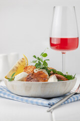 Baked salmon fillet salad with fresh vegetables, cream cheese, lemon, and microgreens.