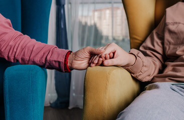 Fototapeta premium close-up of clasped hands in a gesture of support