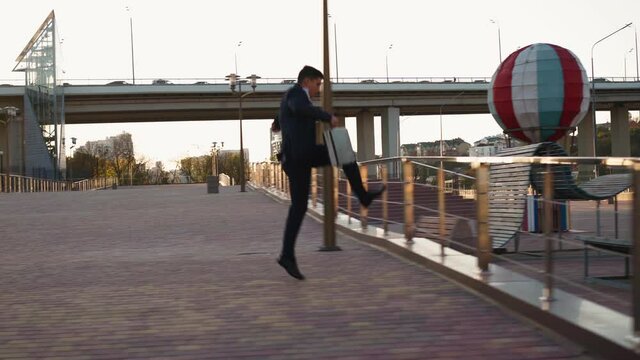 Successful young businessman fast running overcoming obstacles in front of him. Entrepreneur or office worker rushing to work jumping over obstacles on the way. Stuntman in classic clothes.