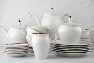 Fototapeta na wymiar porcelain tea set white with gold edging on isolated background