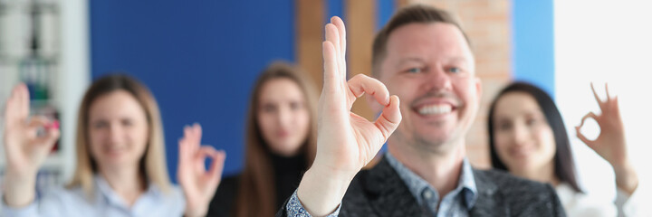Group of business people showing hand gesture ok closeup