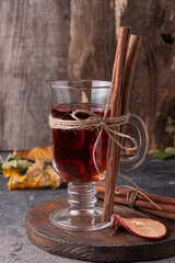 drink with cinnamon and dried fruit stands on a wooden board