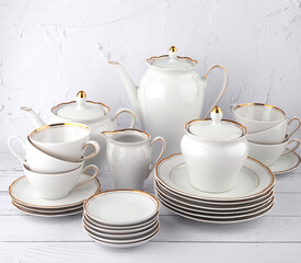 porcelain tea set white with gold edging on isolated background