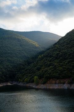 Vallfornis reservoir with a ray of light crossing it and stormy clouds in the background, canoves and samalus Catalonia, Spain