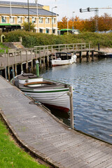 Wooden fishing boats with fishing tackle stand at the pier - the famous open-air fish market in Malmo, Sweden
