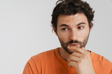 Young brunette man with bristle thinking and looking aside