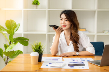 Businesswoman analyzing and brainstorming data, charts, financial reports in the office with laptop and calculator. Ideas for working with financial and investment accounts.