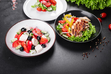 different types of salads on the table menu vegetables, meat, salad fresh portion ready to eat meal snack copy space food background rustic. top view keto or paleo diet