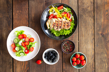 different types of salads on the table menu vegetables, meat, salad fresh portion ready to eat meal snack copy space food background rustic. top view keto or paleo diet