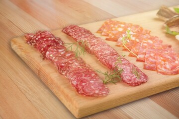 Set of different types of sausages, salami and smoked meat on the desk