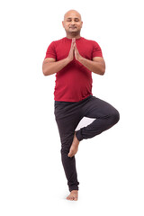 Portrait of a bald man standing and doing yoga against plain white background.