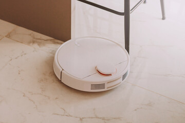 White round hoover cleaner robot cleaning floor at home. Housekeeping. Removing dust and dirty.