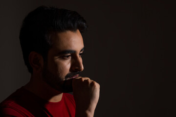 PORTRAIT OF A MAN POSING AND LOOKING DOWN