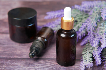 Essential lavender oil and flowers on table with copy space 