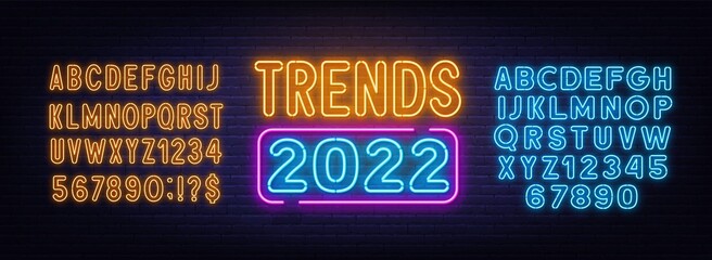 Trends 2022 neon sign on brick wall background.