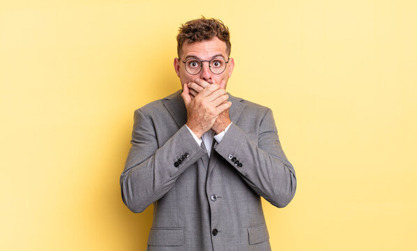 young handsome man covering mouth with hands with a shocked. business concept