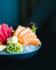 Different kind of (ebi, sake, unagi, maguro) sashimi on ice in a bowl at a restaurant