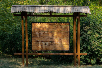 Wooden rectangular board from bars background for ads, against the backdrop of greenery in the recreation park