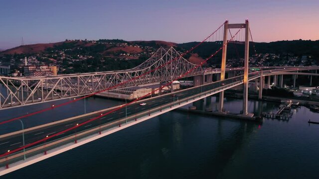 Aerial: Freeway traffic on the Alfred Zampa Memorial Bridge and Carquinez Bridge at night between Oakland and Vallejo. California, USA
