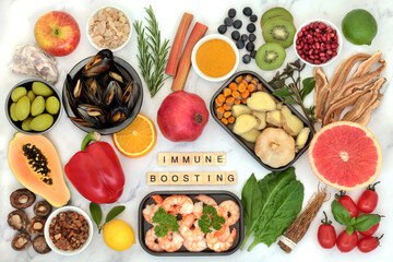 Fototapeta na wymiar Immune system boosting health food with title, seafood, vegetables, fruit, herbs and spice on marble. Foods high in antioxidants, anthocyanins, protein, fibre, vitamins, minerals and omega 3. 