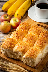 Breakfast table with coconut bread and fruits.
