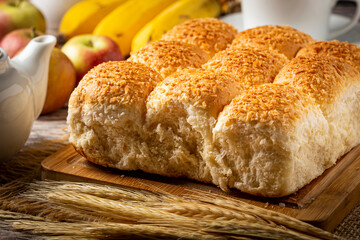 Breakfast table with coconut bread and fruits.