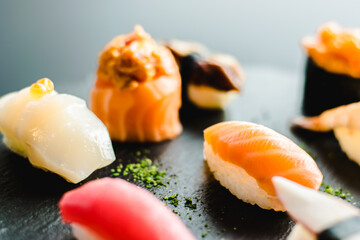Maki and nigiri sushi variety with salmon, shrimp, avocado and tuna at a sushi restaurant