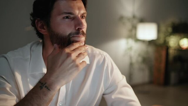 A Close-up View Of Pensive Man Thinking About Something In The Office At Night