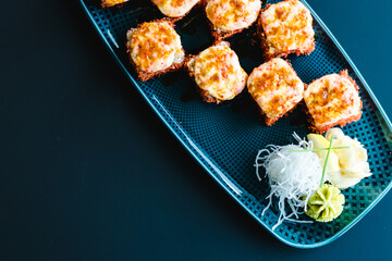 Maki and nigiri sushi variety with salmon, shrimp, avocado and tuna at a sushi restaurant