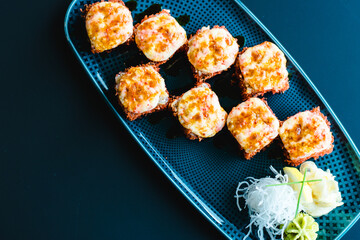 Maki and nigiri sushi variety with salmon, shrimp, avocado and tuna at a sushi restaurant